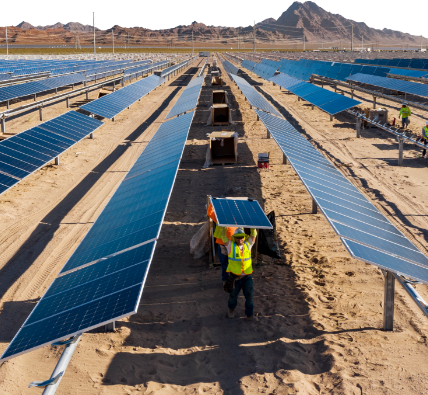 An array of solar panels being installed in the desert